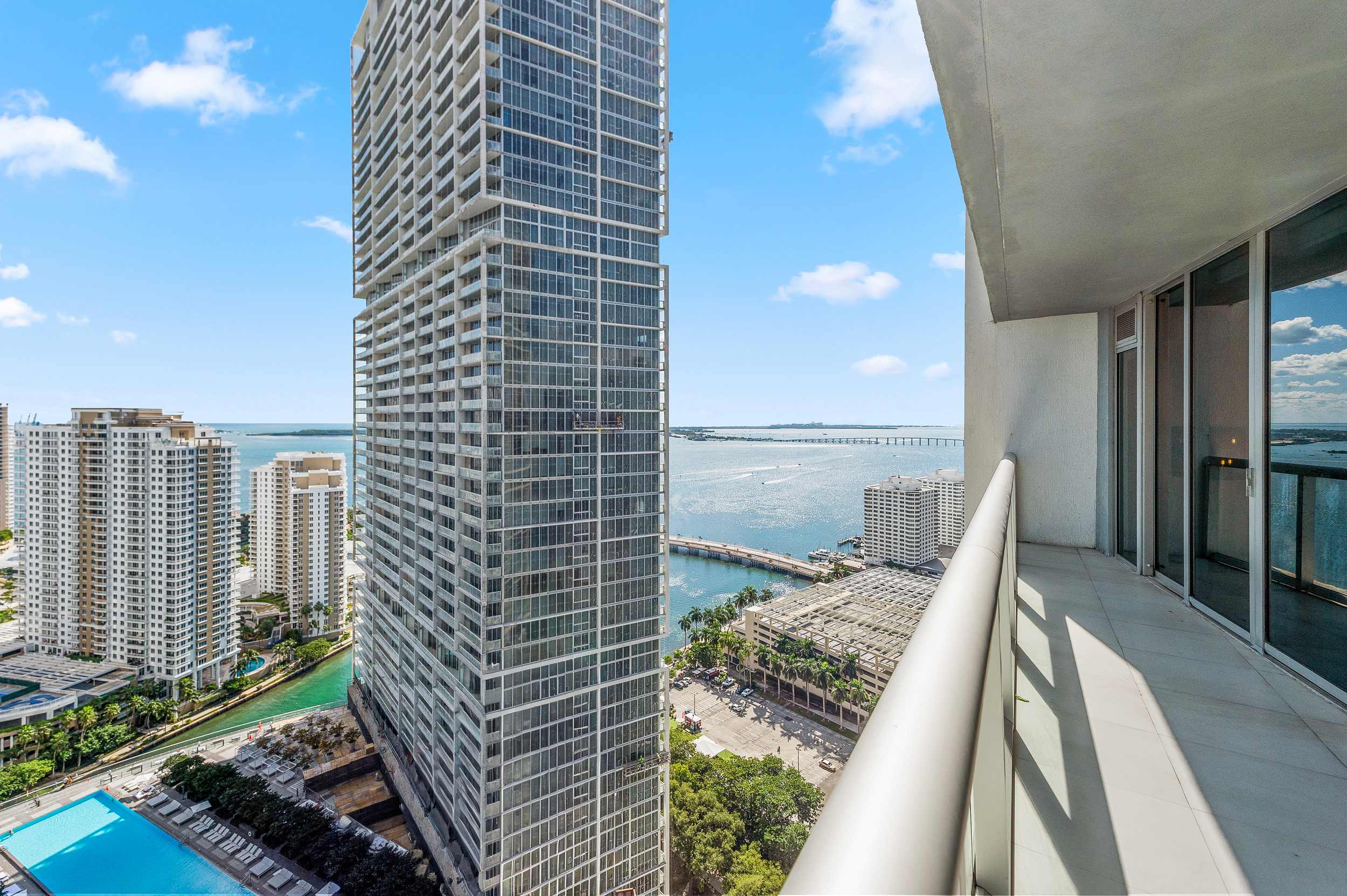 Curved balcony overlooking towers and the bay.