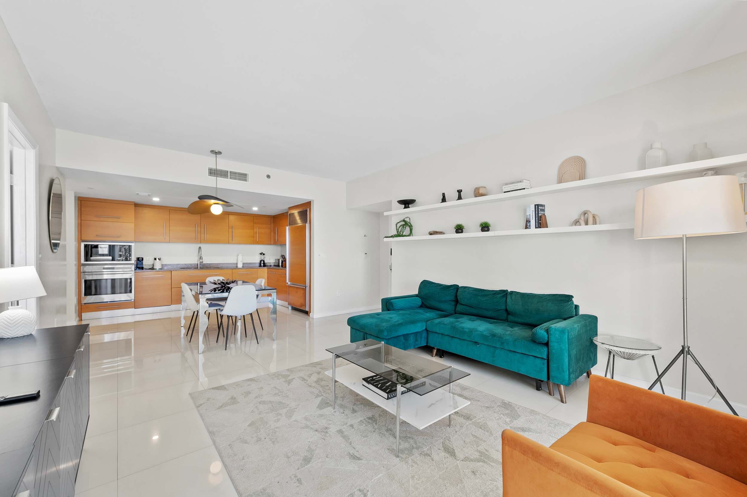 Open living area beside a wood-finished kitchen.