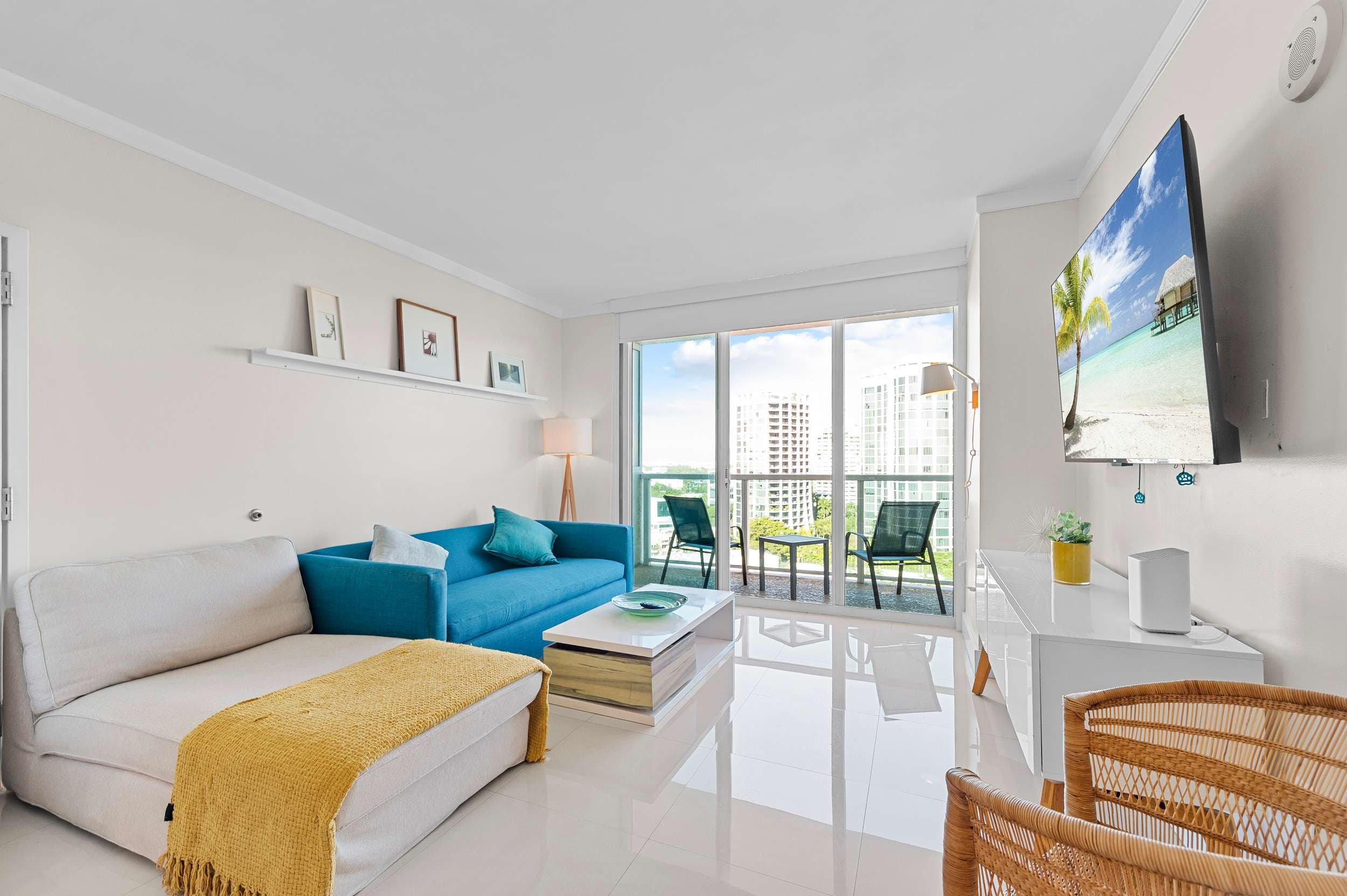 Living area with a sofa and television.