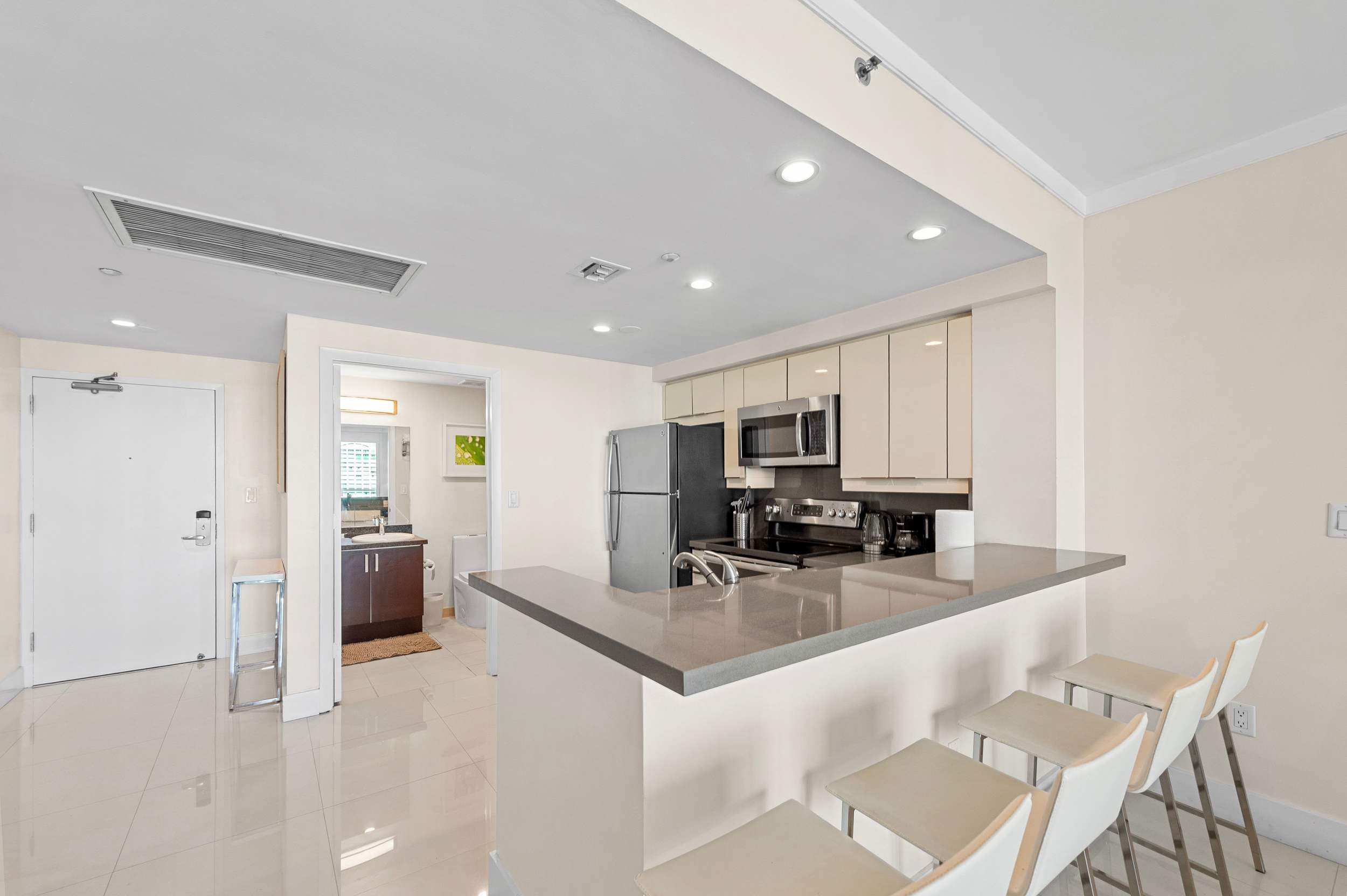 Kitchen breakfast counter with bar stools.