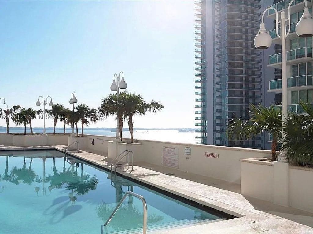 The outdoor pool terrace and sun loungers at The Club at Brickell Bay