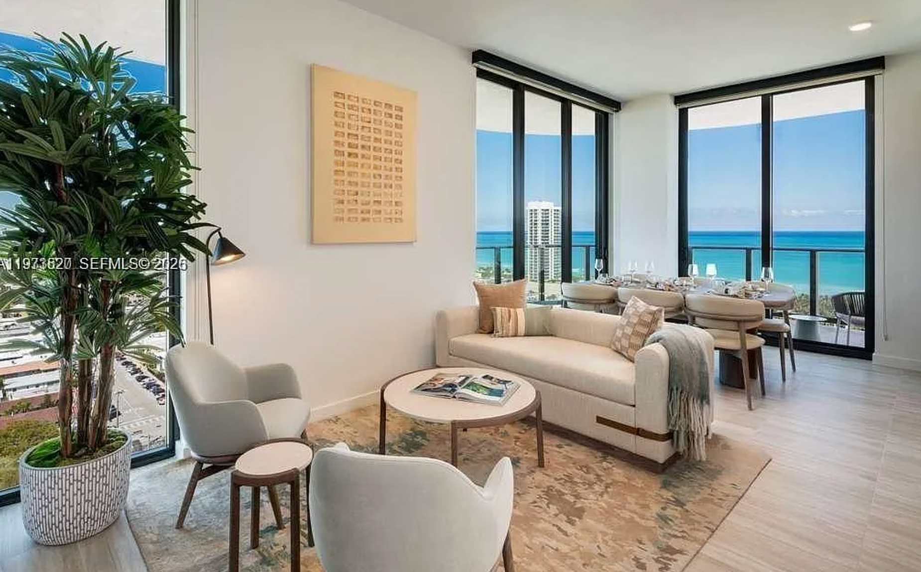 Living room with cream seating and ocean views.