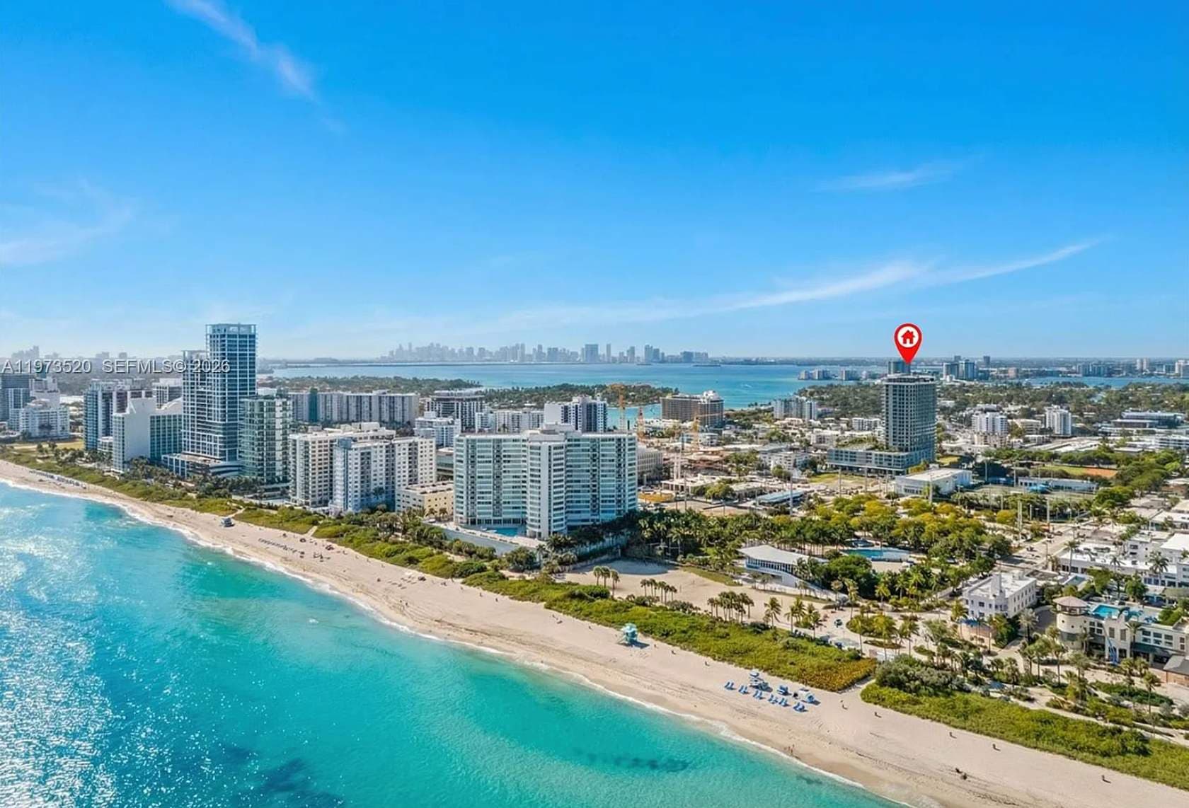 Aerial view of the beach and coastal buildings.