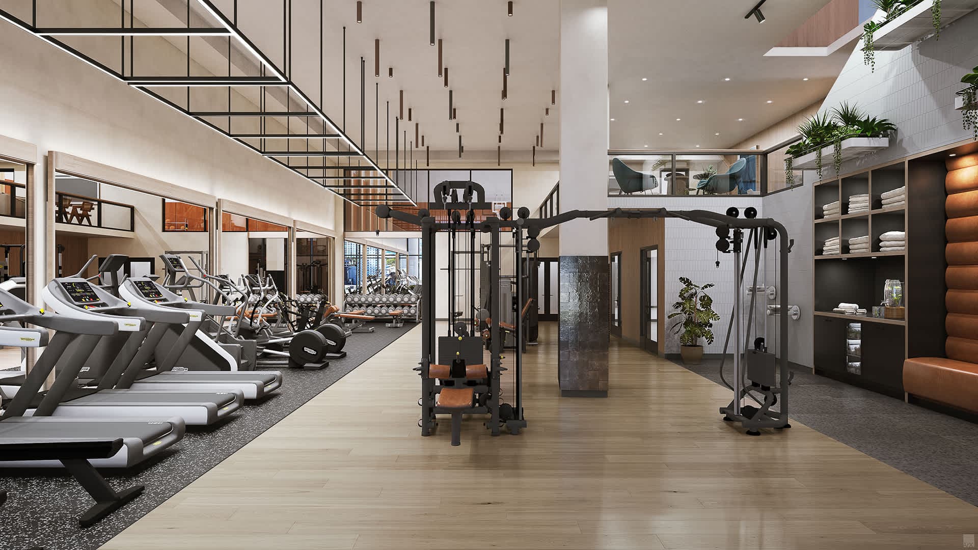 Gym with exercise machines and large windows.