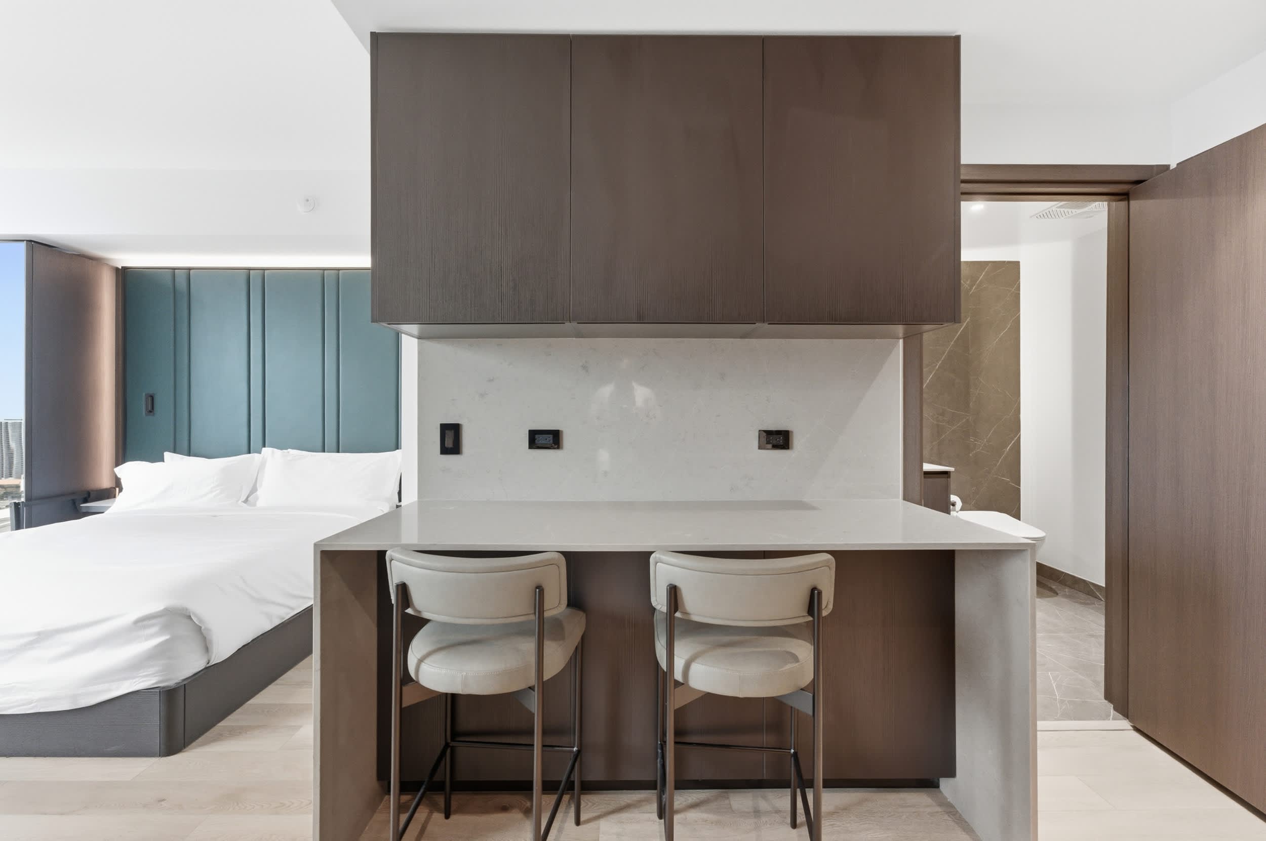 Breakfast bar with two upholstered stools.