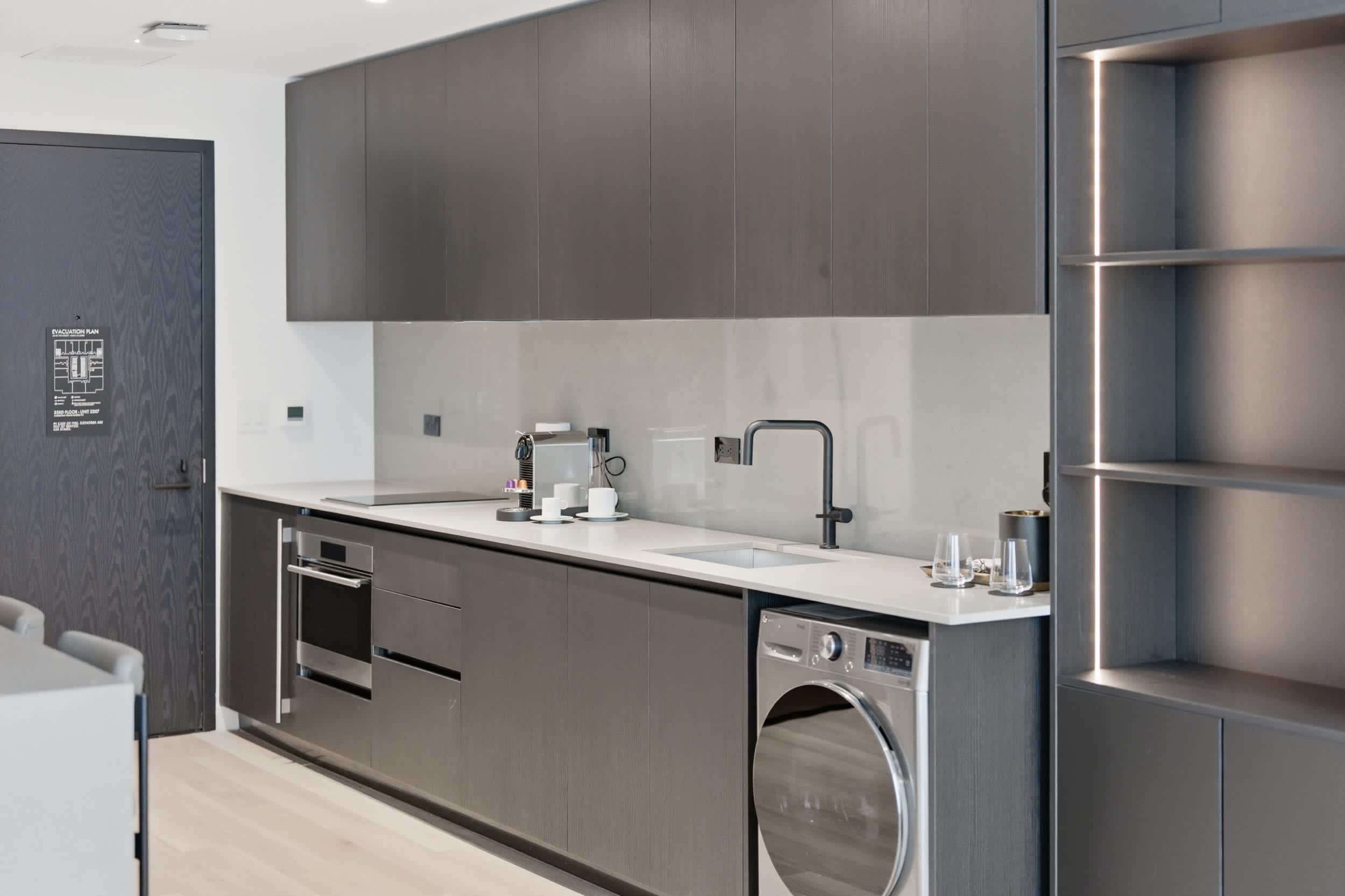 Galley kitchen with an under-counter washer.