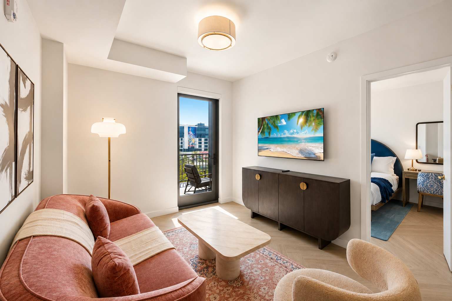 Living room with a pink sofa and television.
