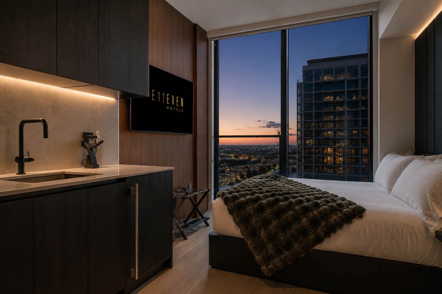 Compact kitchen and bed at dusk.