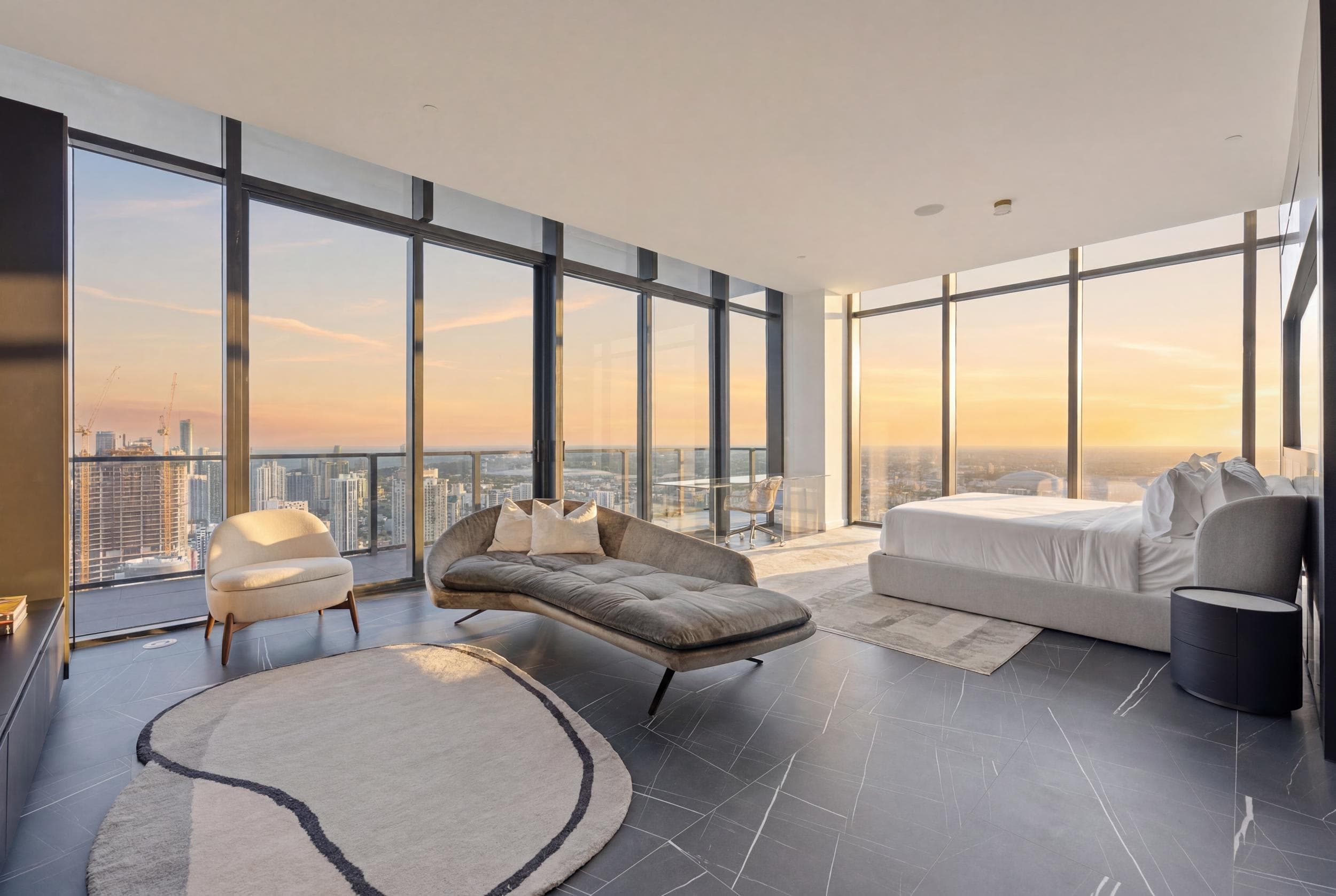 Bedroom with a chaise lounge and sunset views.