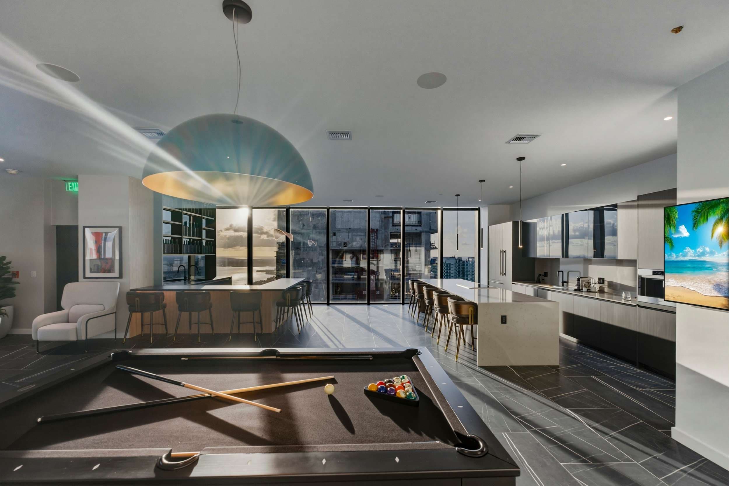 Billiards table beside the kitchen and home bar.