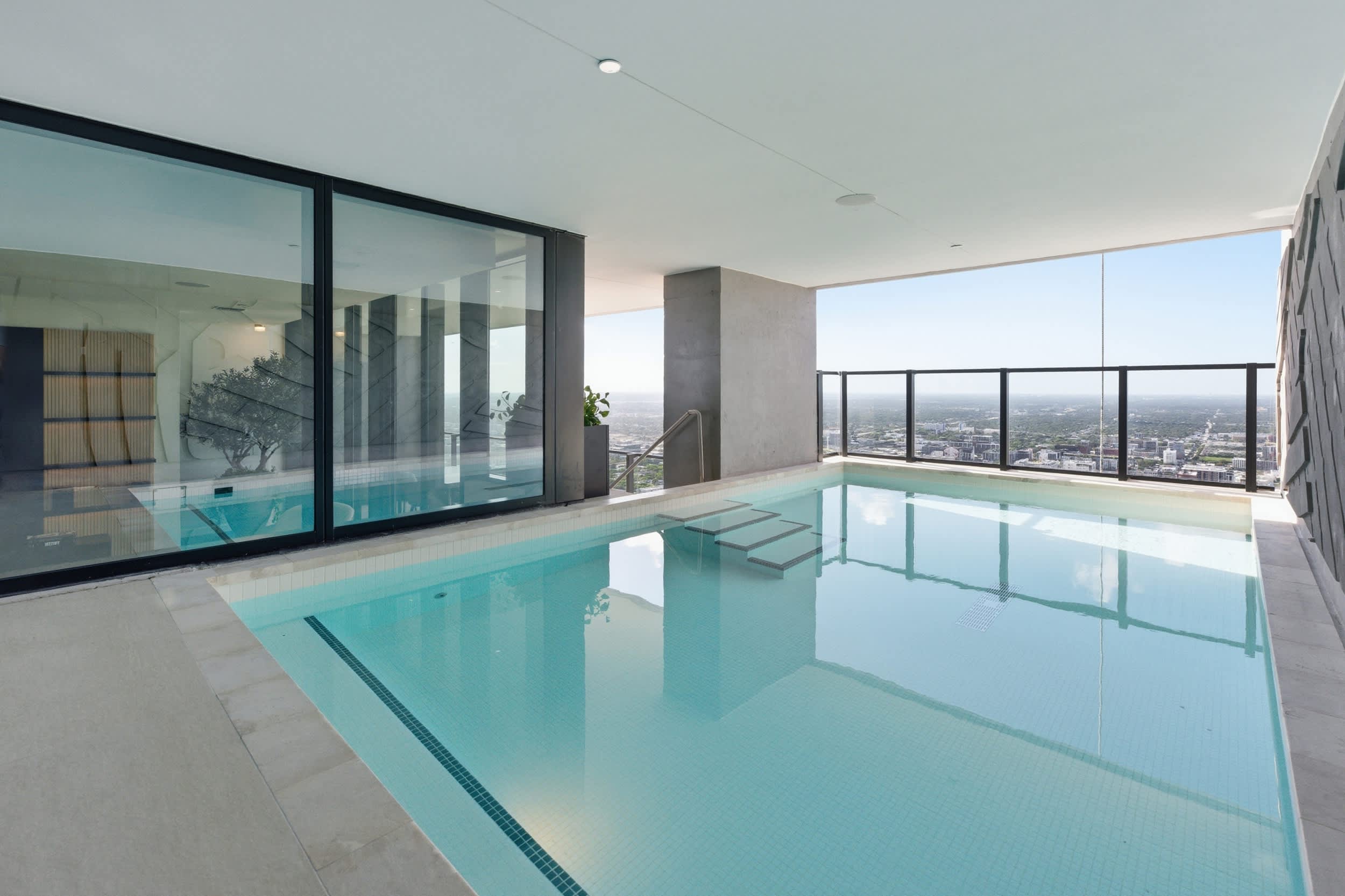 Covered terrace pool overlooking the city.