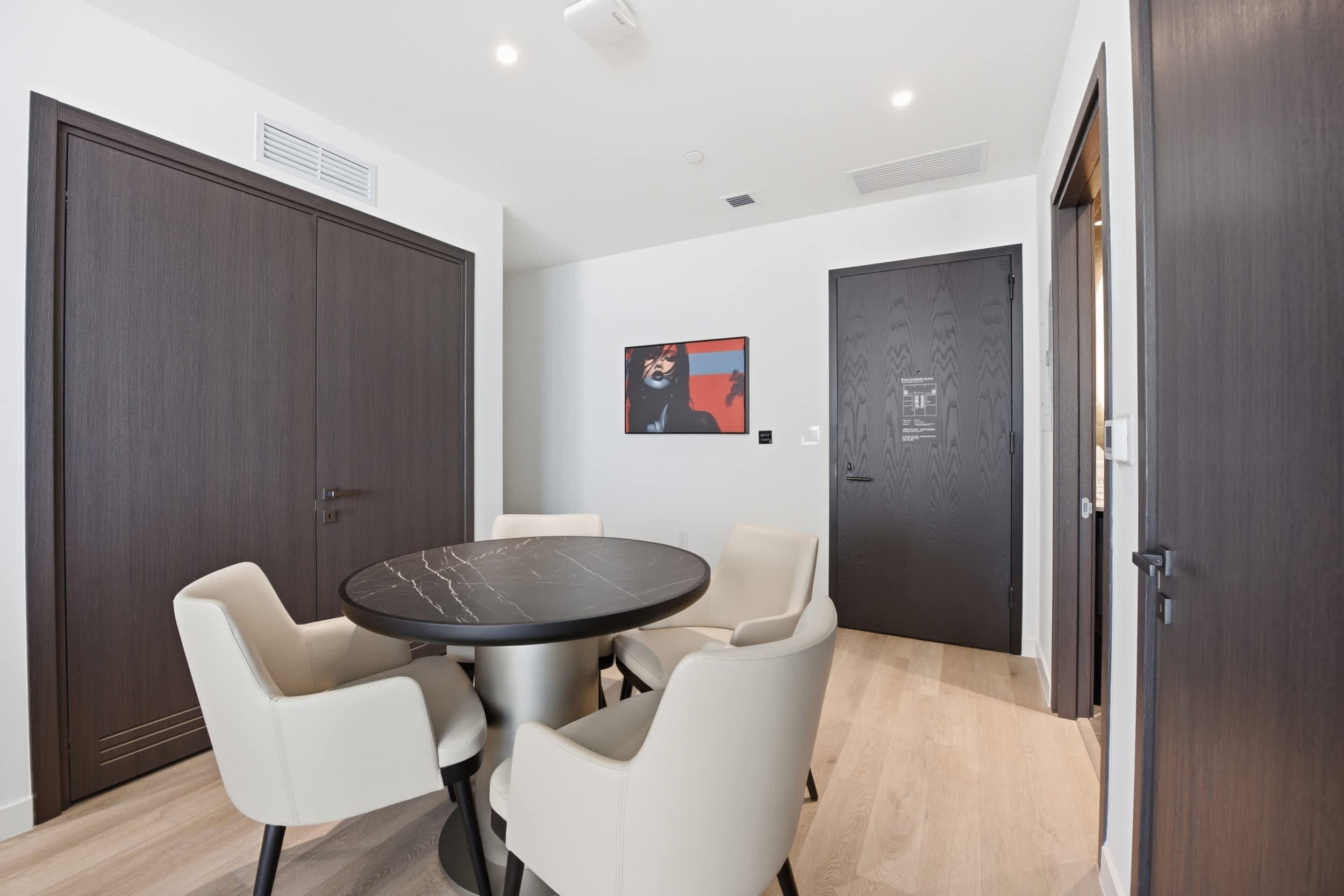 Round dining table with upholstered chairs.
