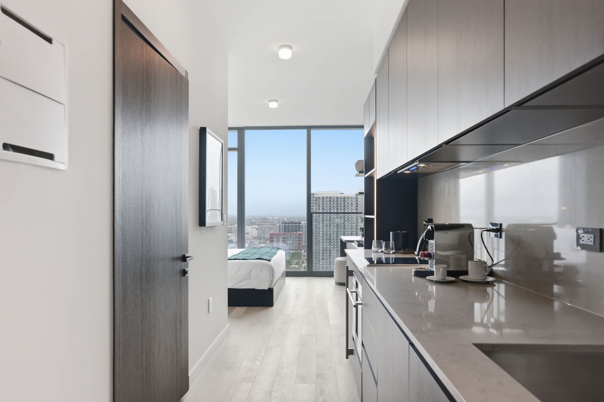 Galley kitchen opening toward the bright studio.