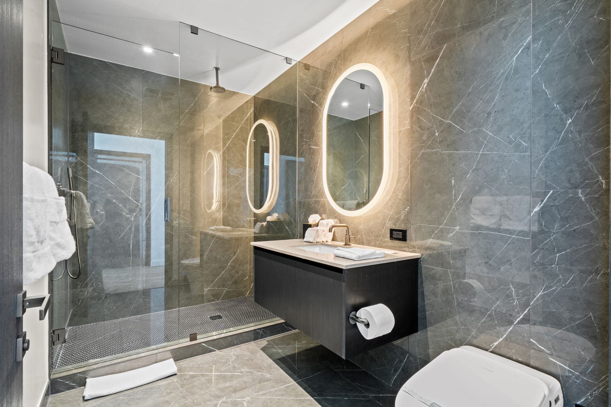 Bathroom with a floating vanity and glass shower.