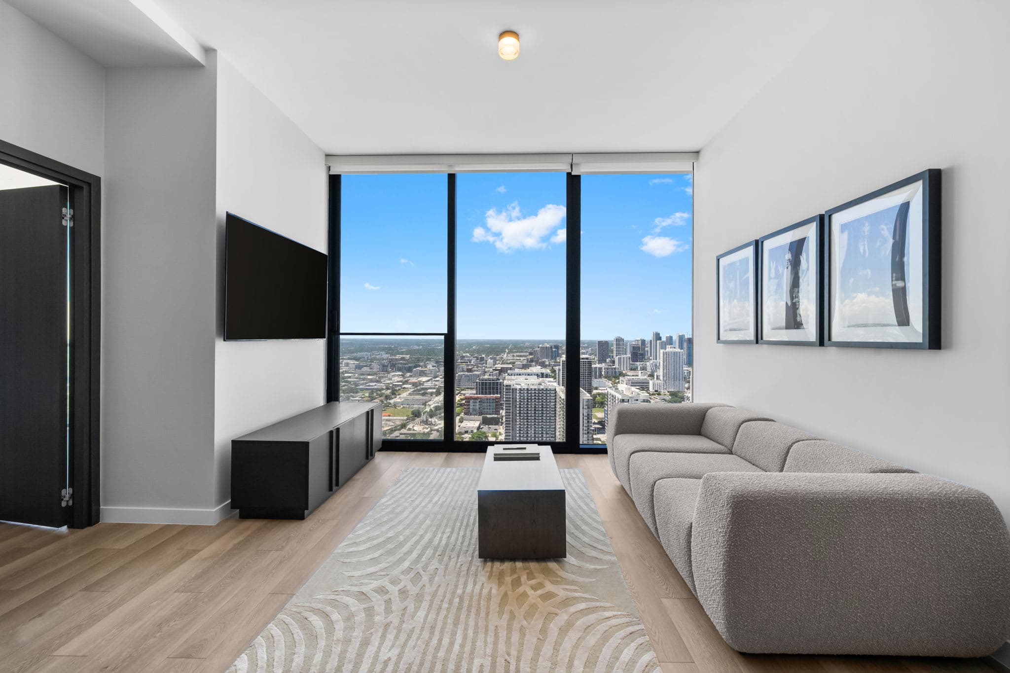 Living room with a sofa and city-view windows.