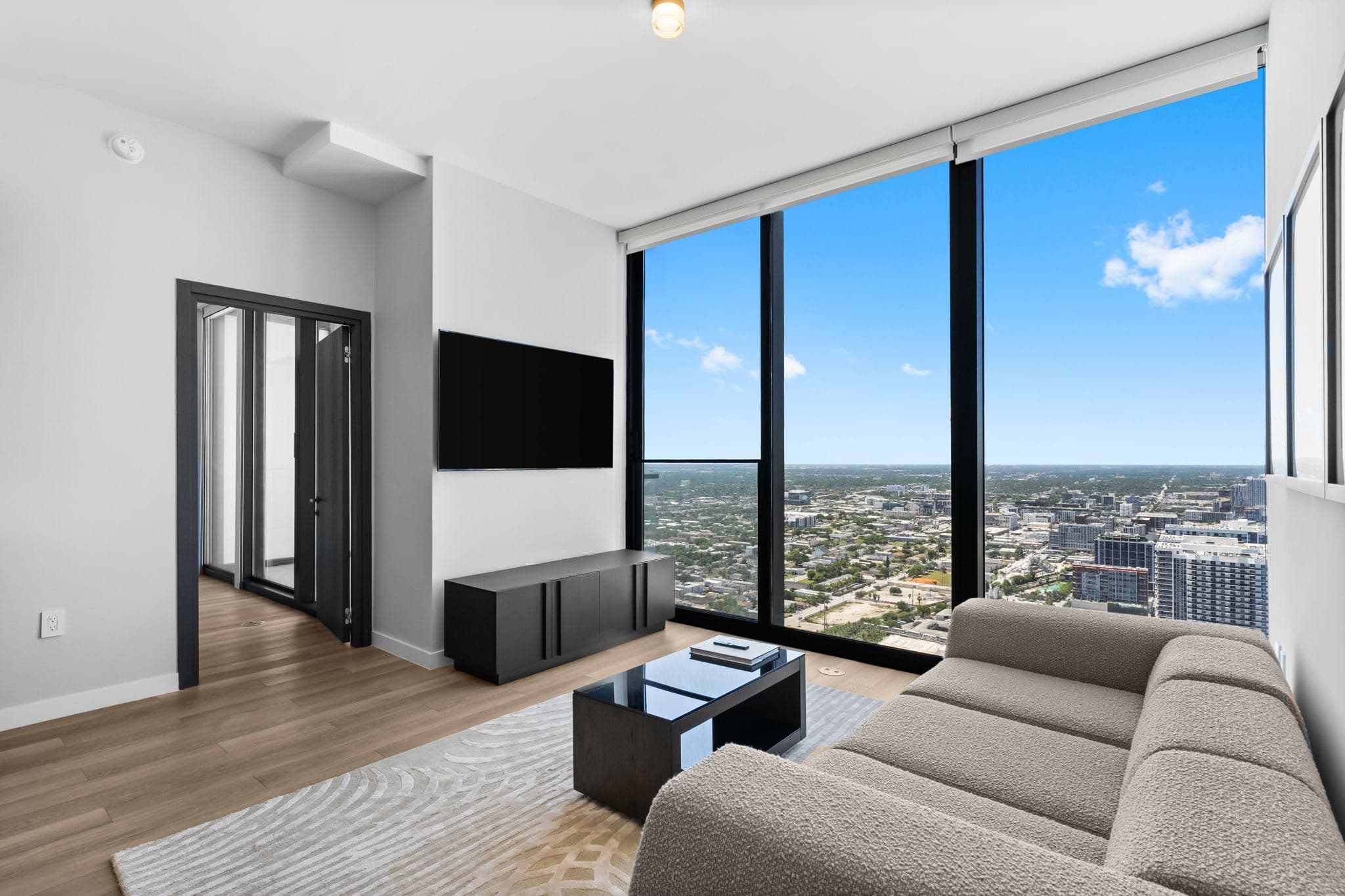 Living room with a sofa and city-view windows.