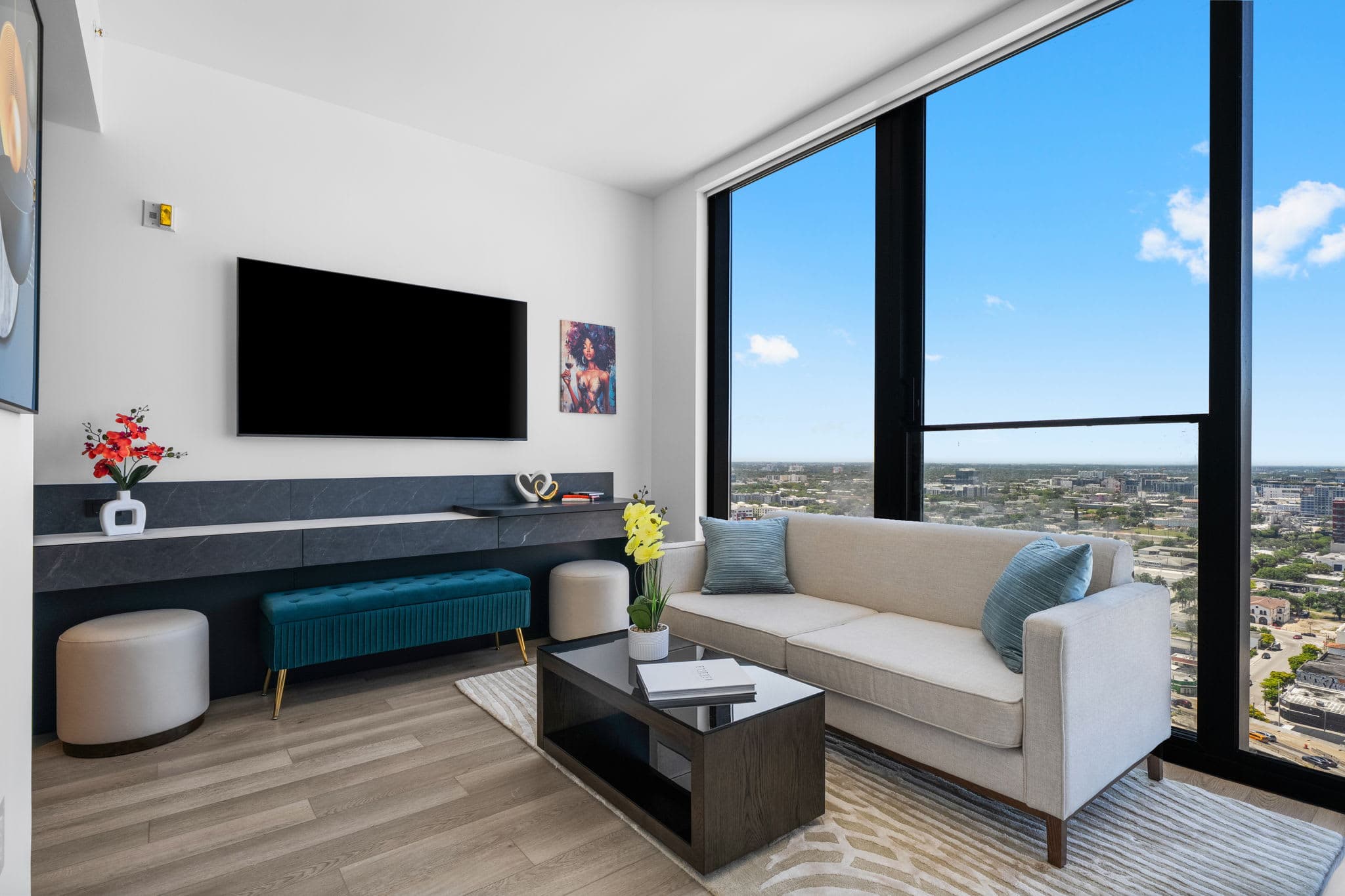 Sofa and coffee table beside a wall-mounted TV.