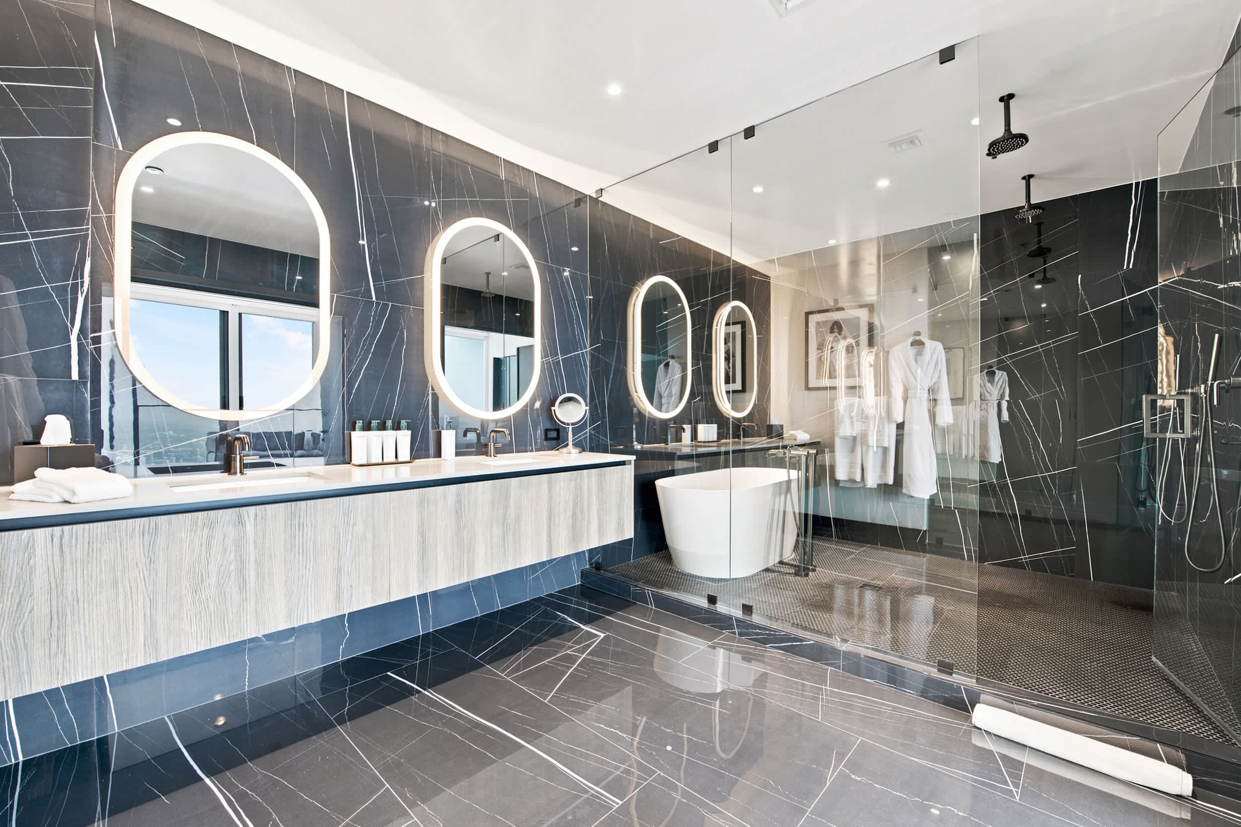 Bathroom with a long vanity and glass shower.