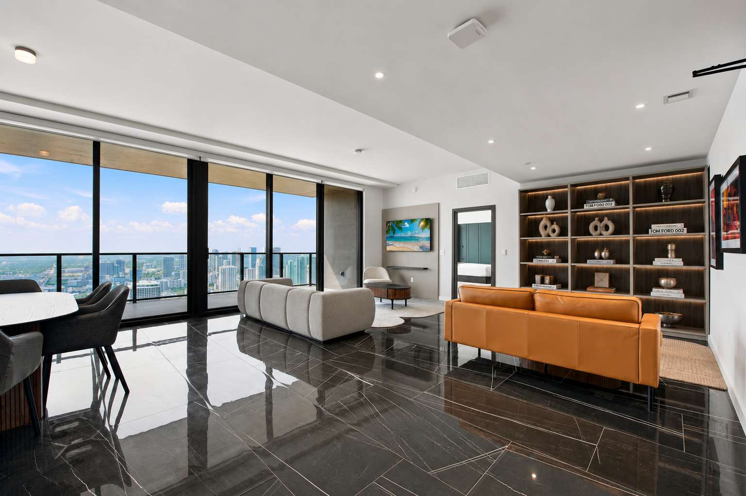 Living area with pale sofas and an orange sofa.