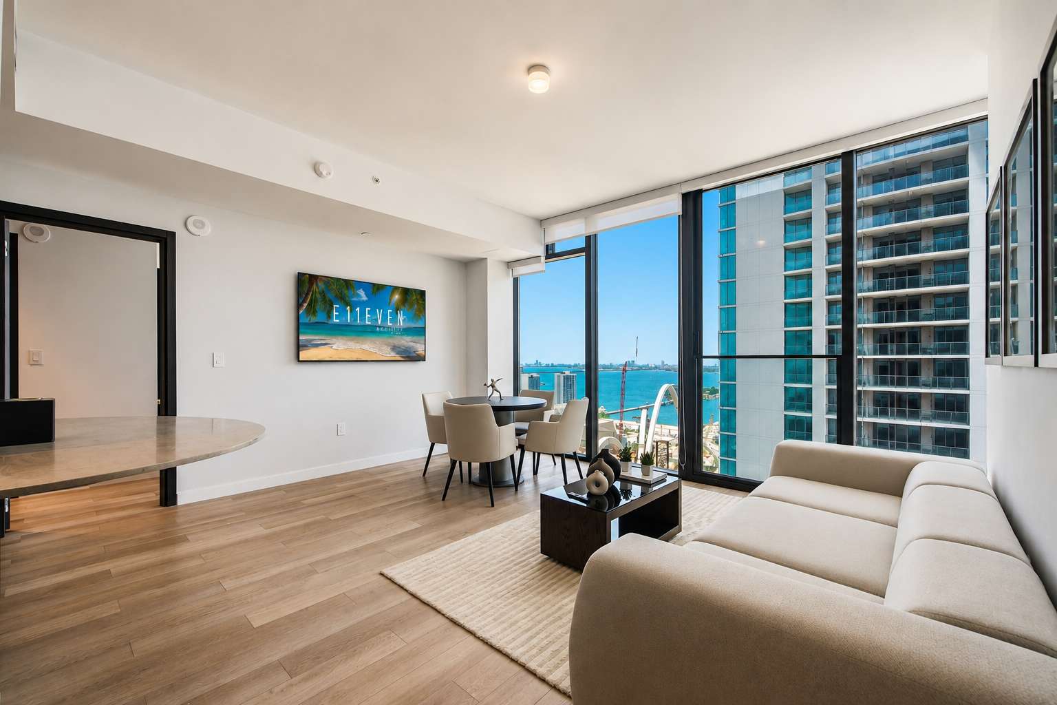 Living room with a sofa and city-view windows.