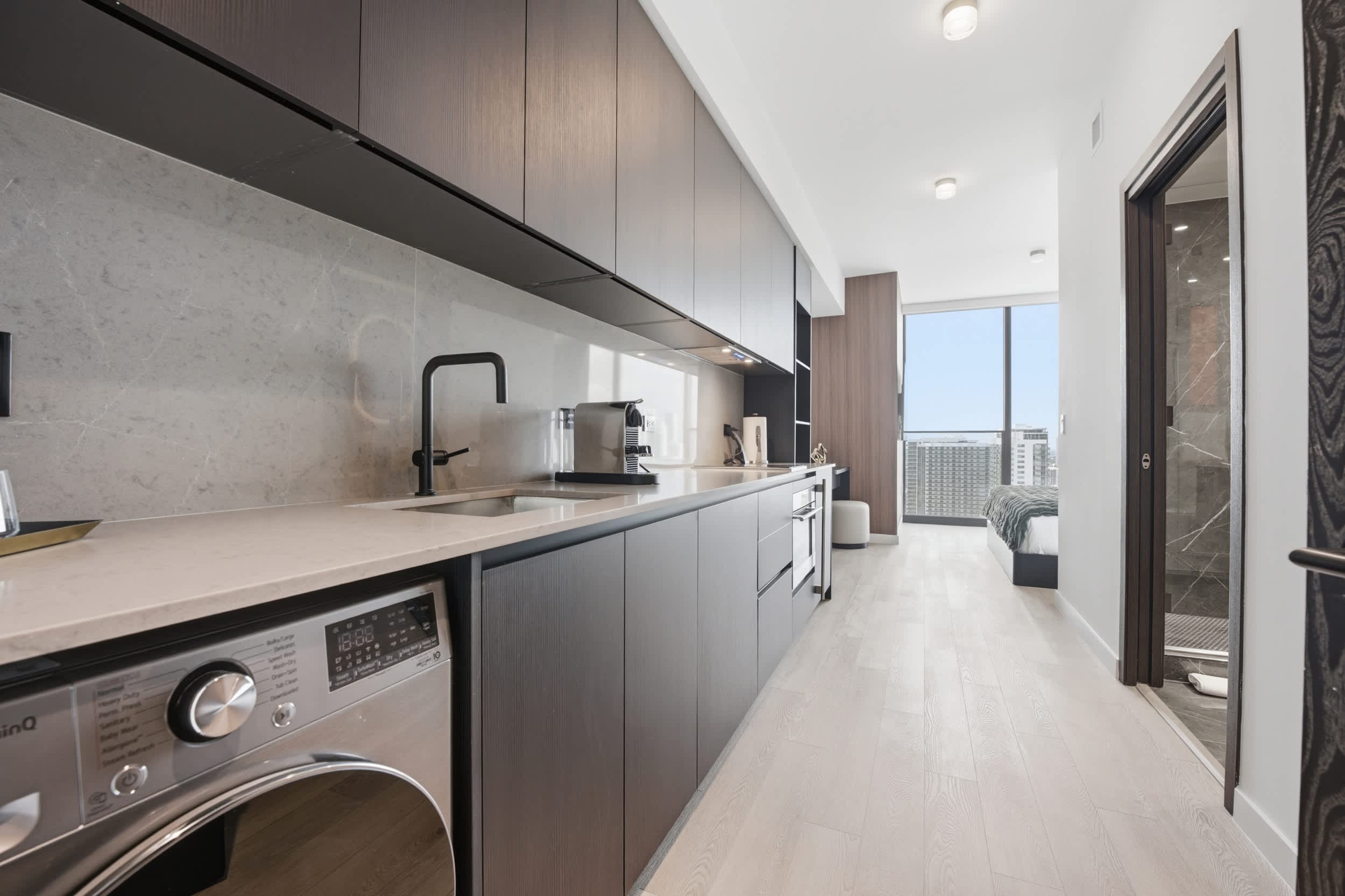 Galley kitchen with an under-counter washer.