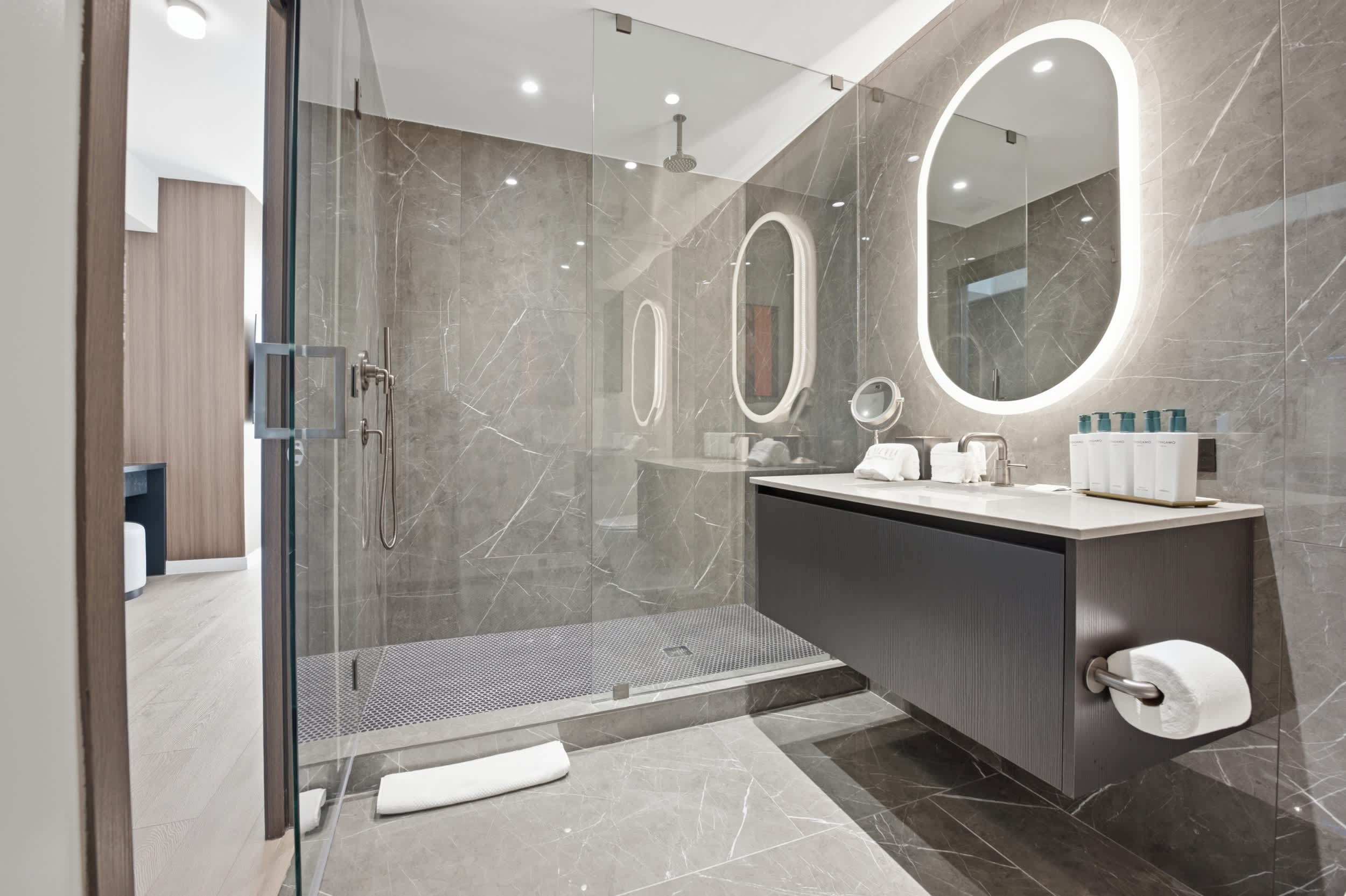Bathroom with a floating vanity and glass shower.