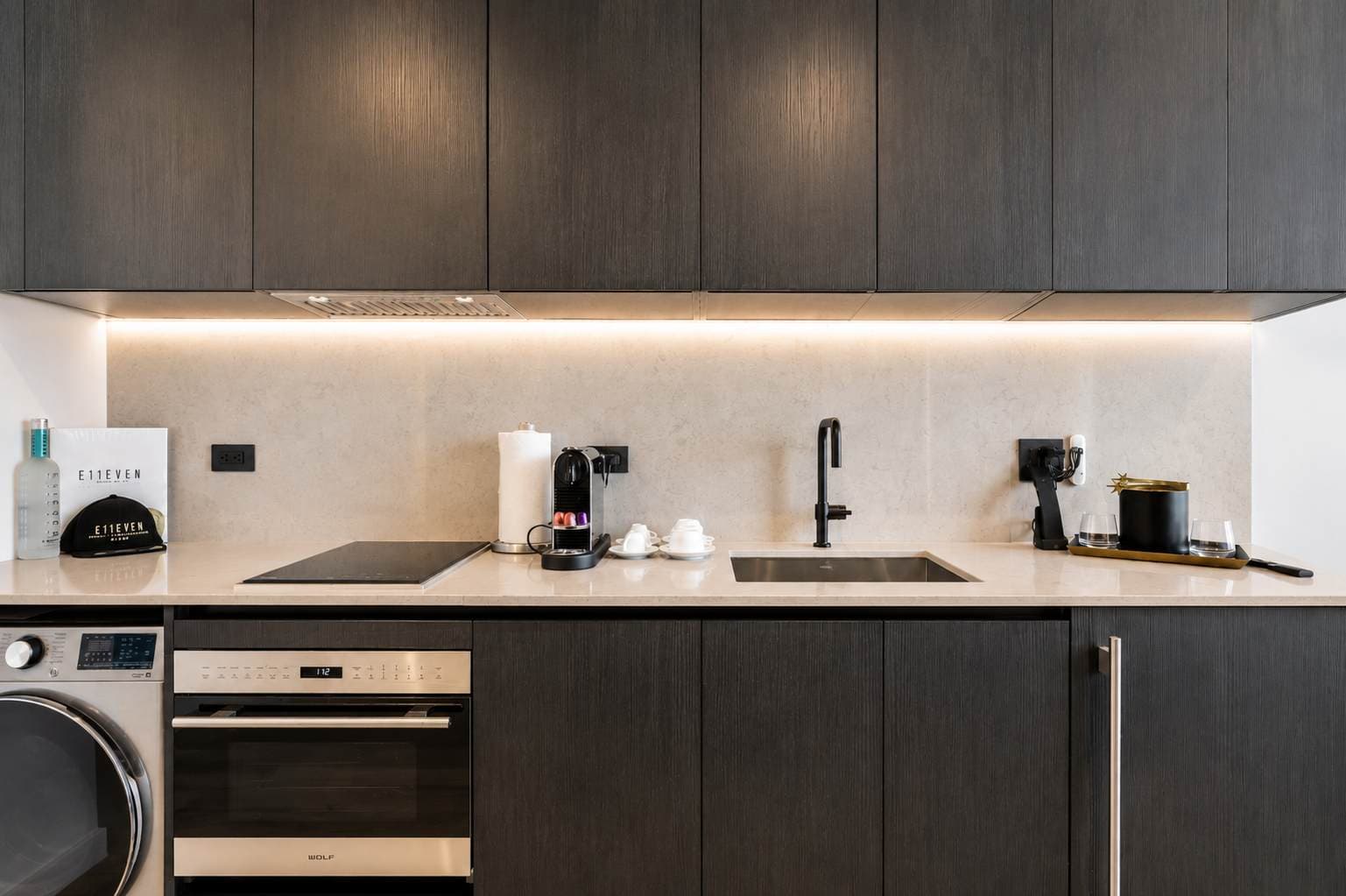 Kitchen with dark cabinets and built-in appliances.