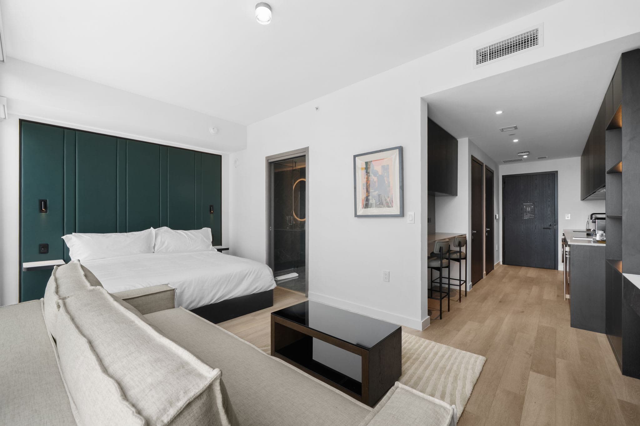 Studio bedroom with a sofa and coffee table.