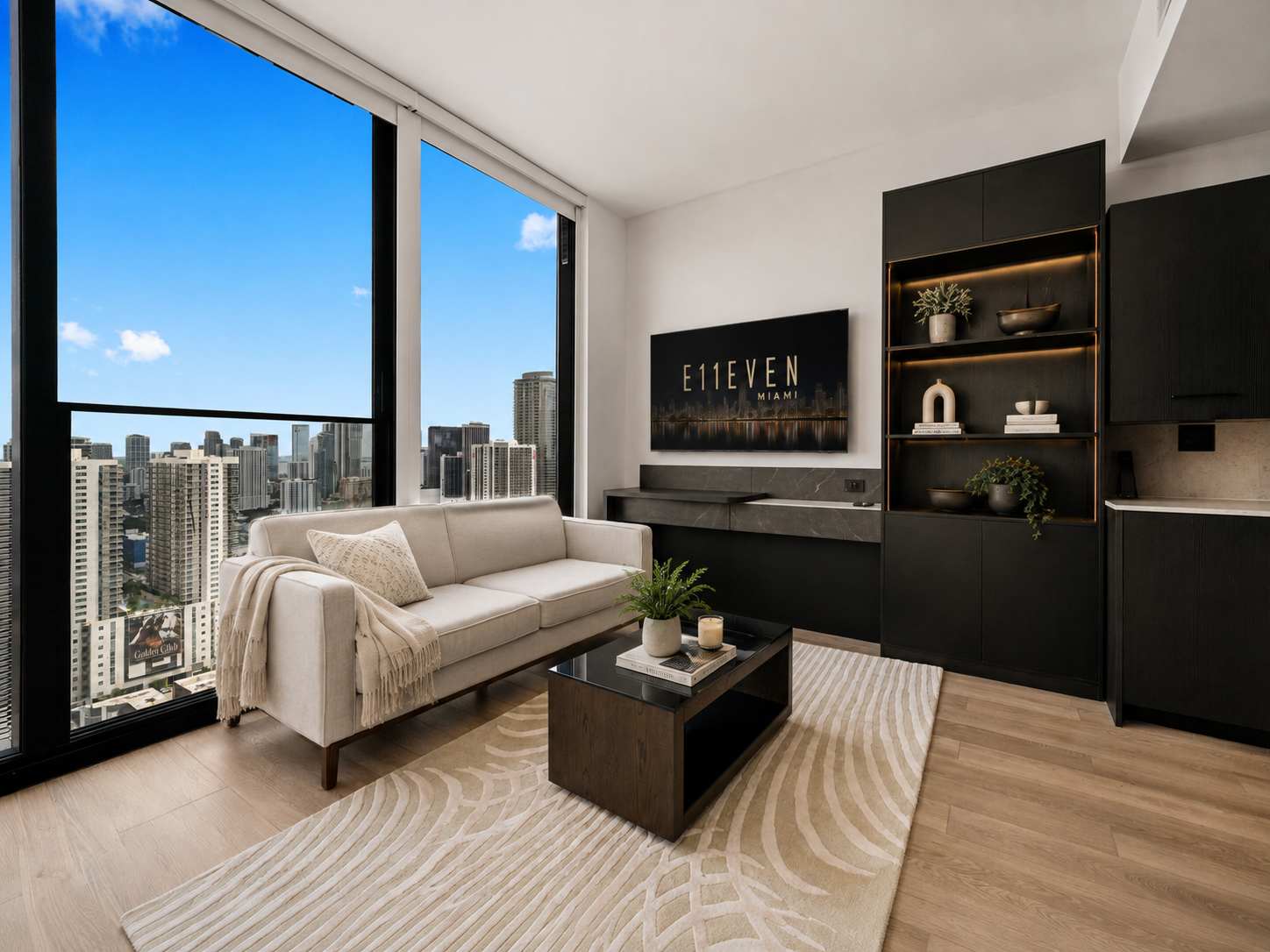 Sofa and coffee table beside a wall-mounted TV.