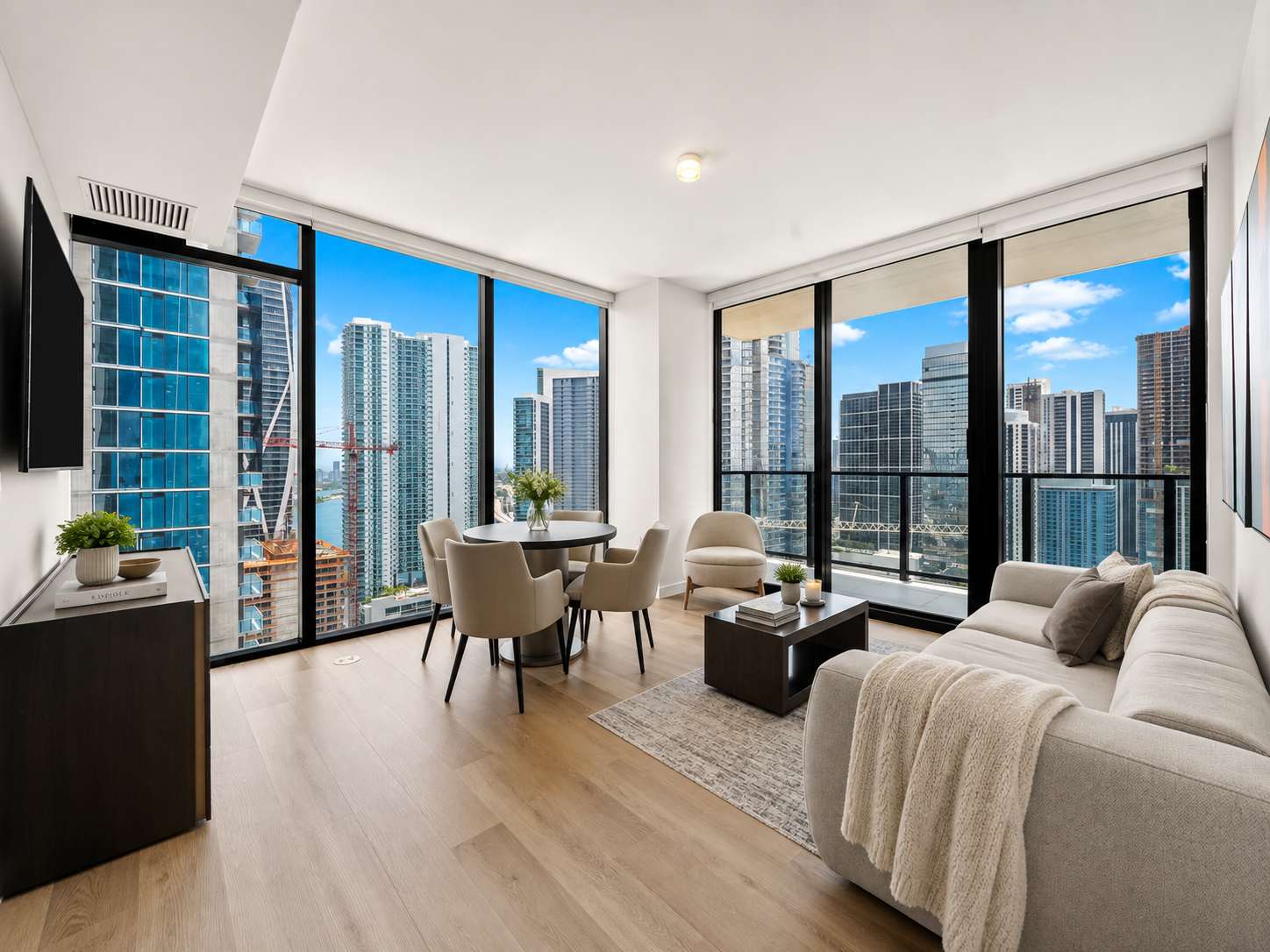 Living room with a sofa and city-view windows.