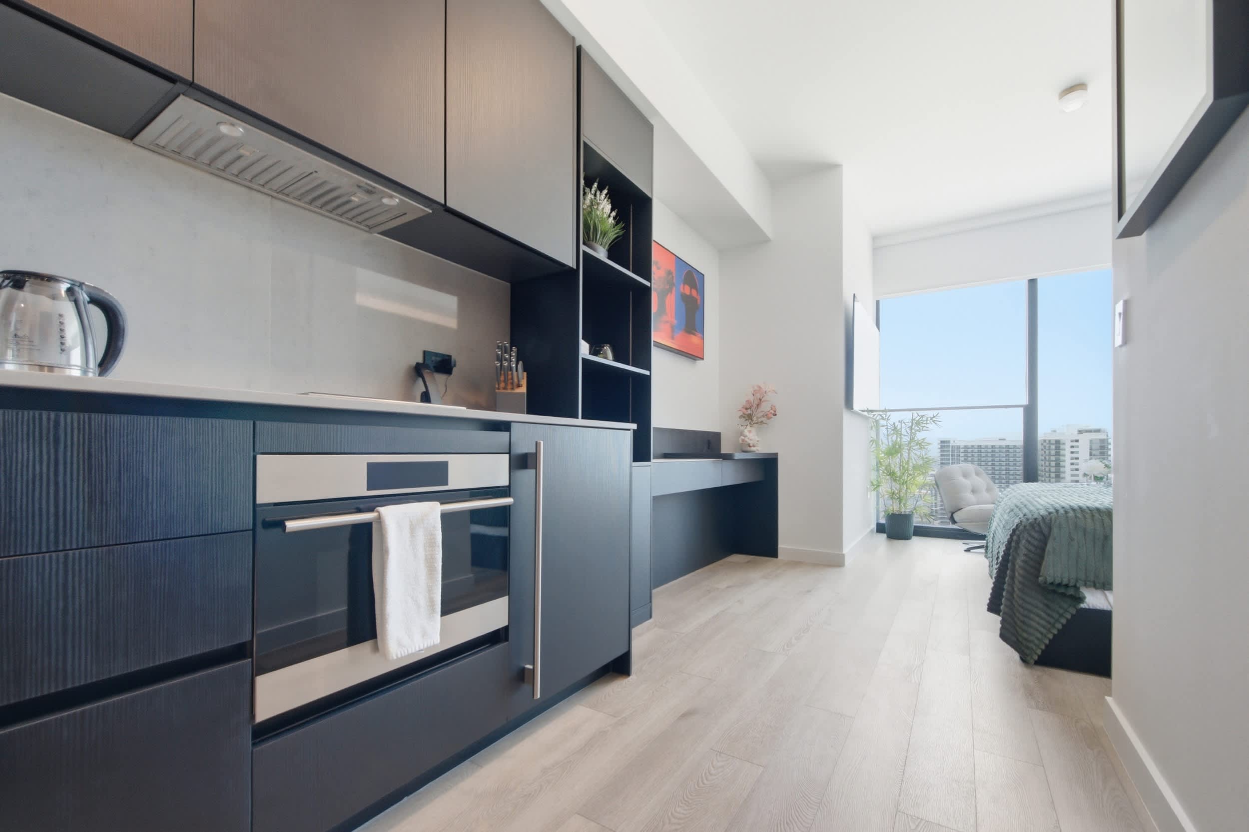Kitchen with a built-in oven beside the bedroom.