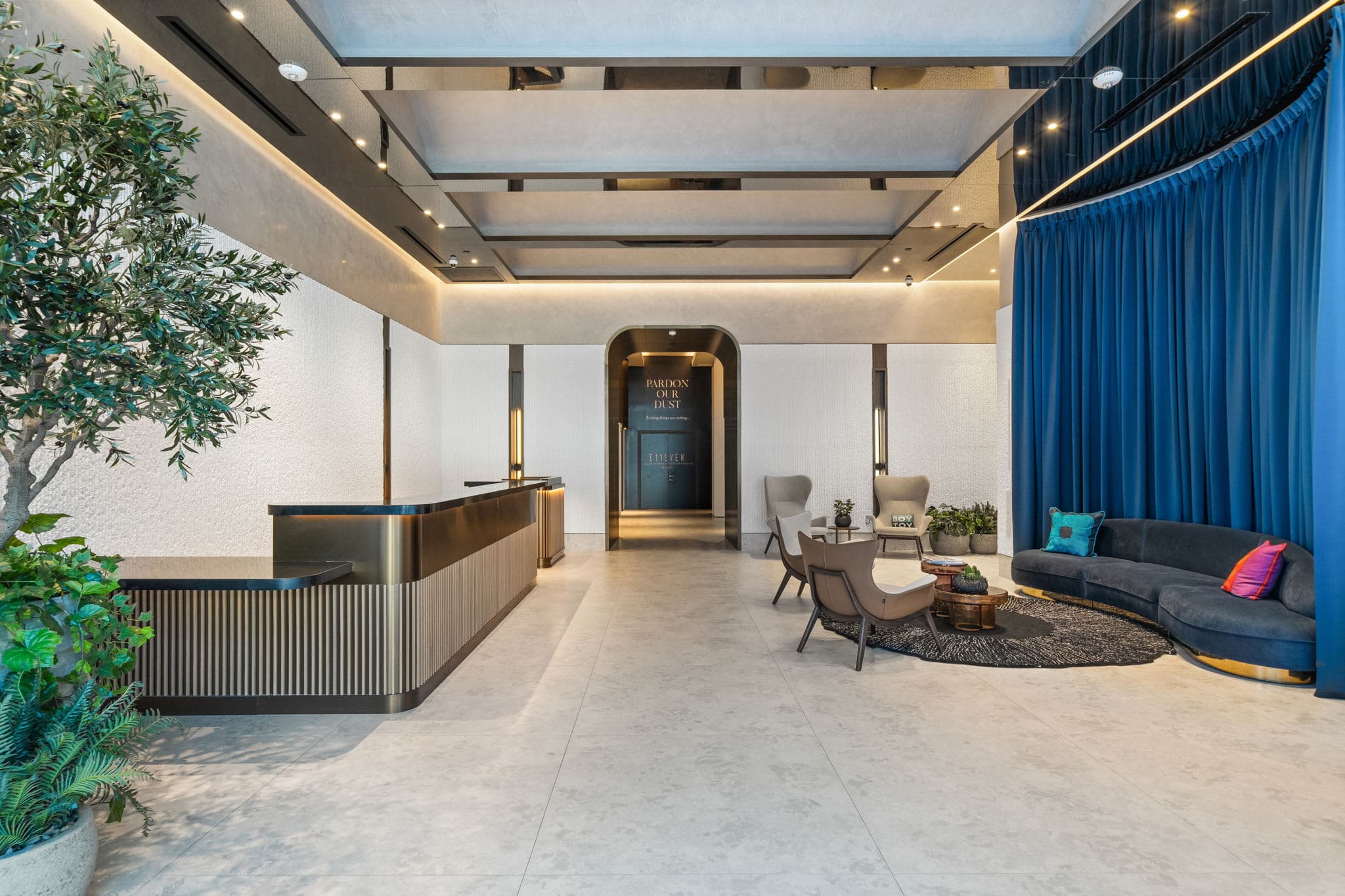 Lobby with a blue curtain and seating area.
