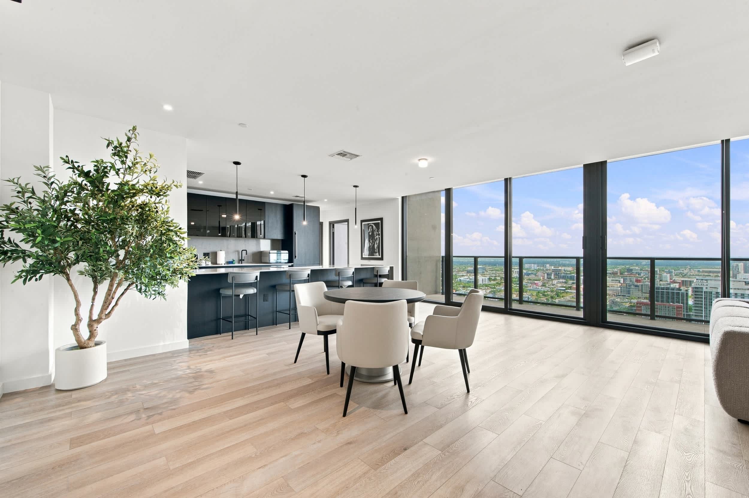 Dining area beside the kitchen and tall windows.