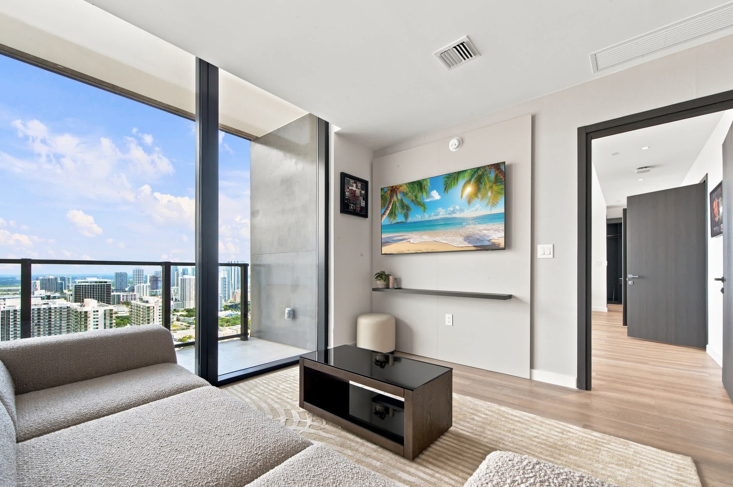 Living room with a sofa and city-view windows.