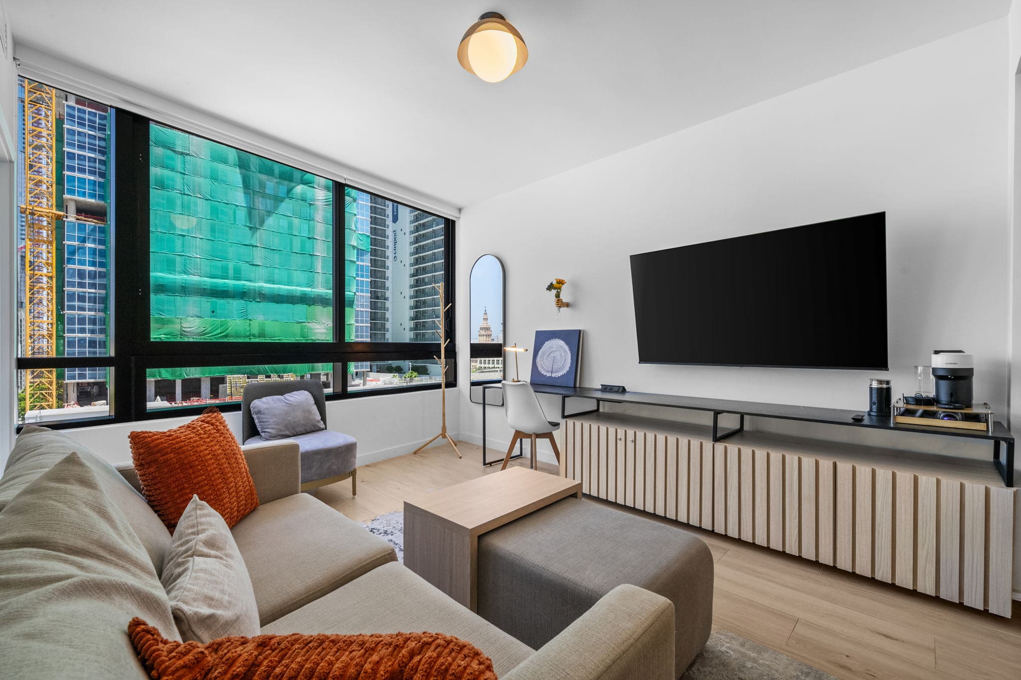 Living area with a sofa and television.