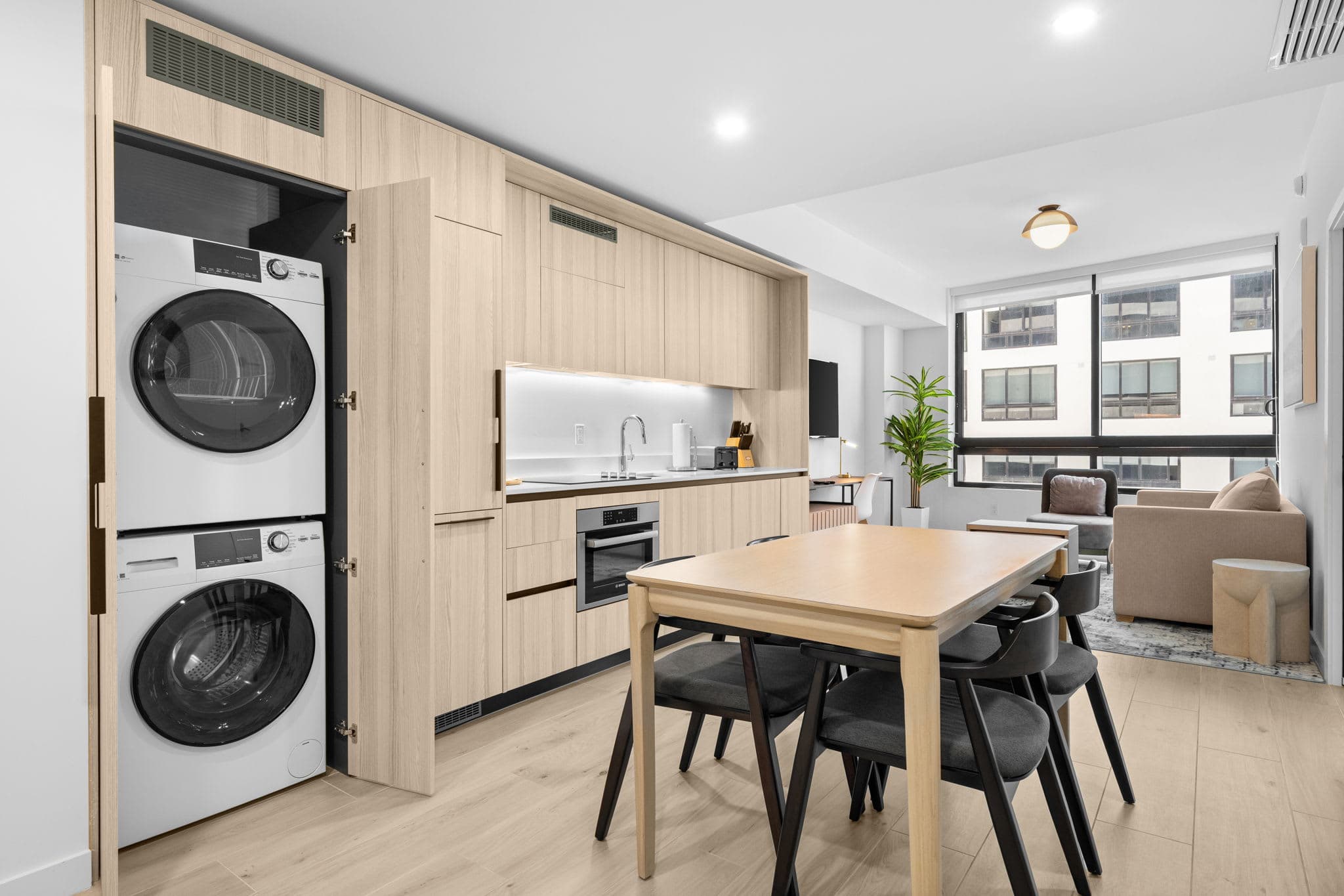 Kitchen and dining area beside laundry appliances.