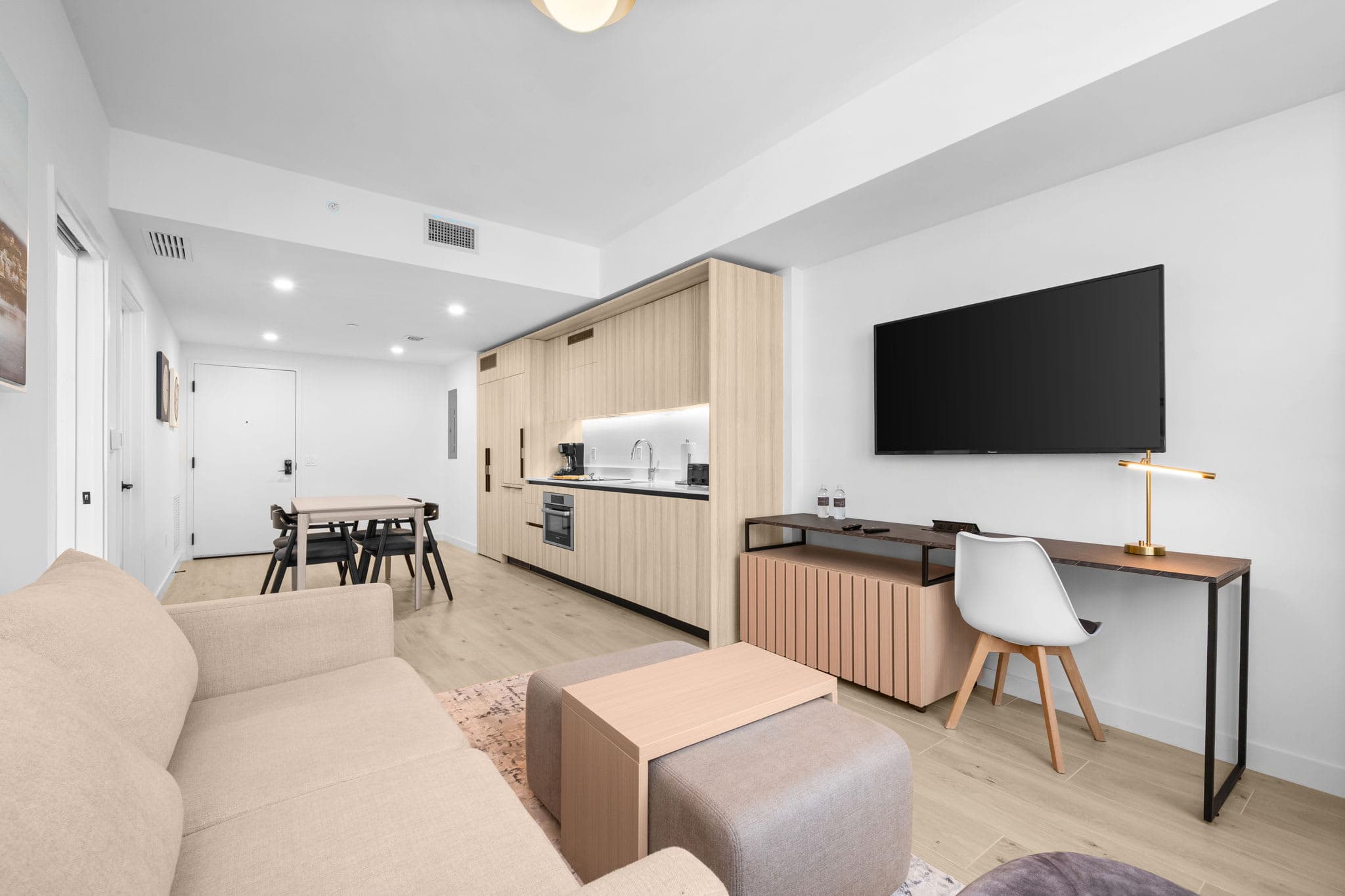 Living area with a sofa and television.