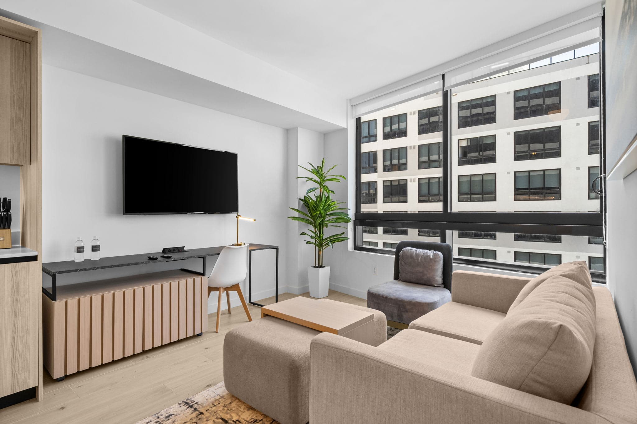 Living area with a sofa and television.
