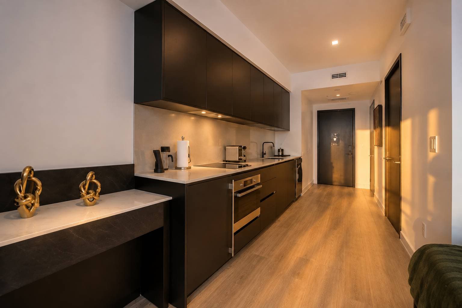 Kitchen with dark cabinets and built-in appliances.