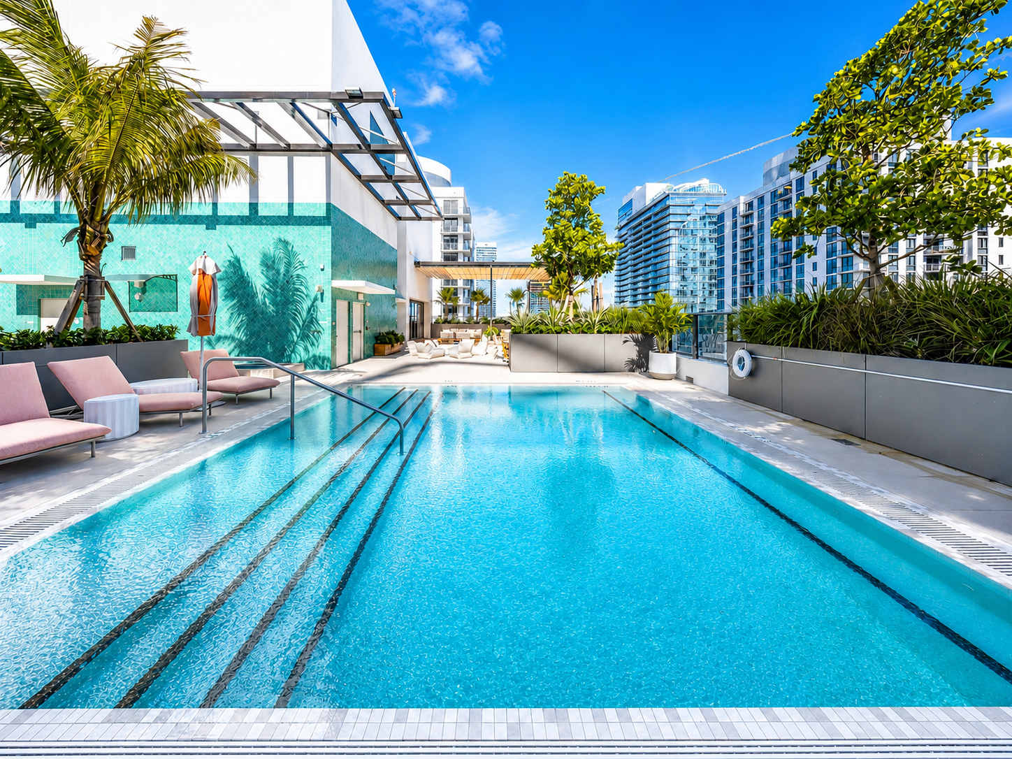 Swimming pool beside a furnished rooftop terrace.