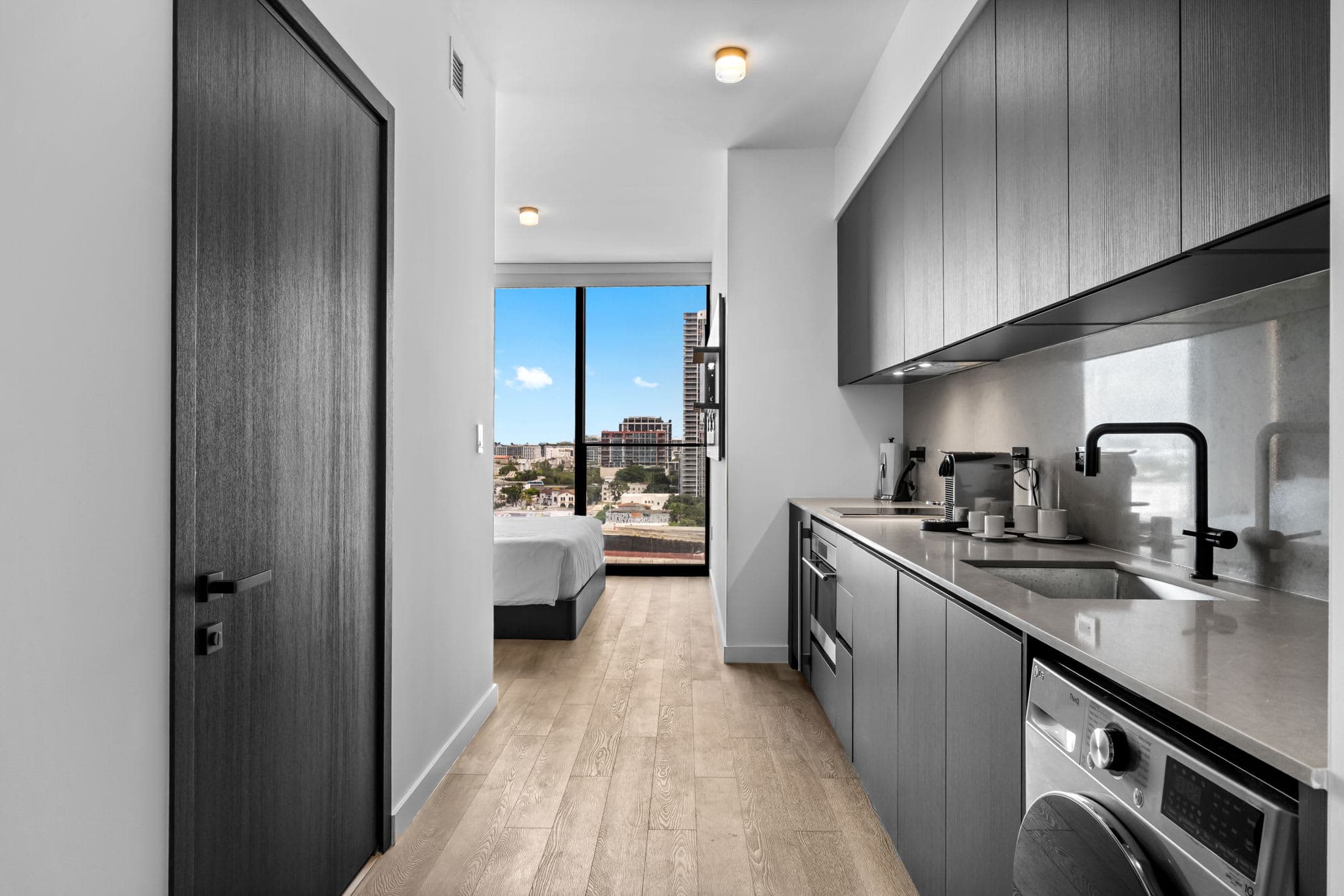 Galley kitchen opening toward the bright studio.