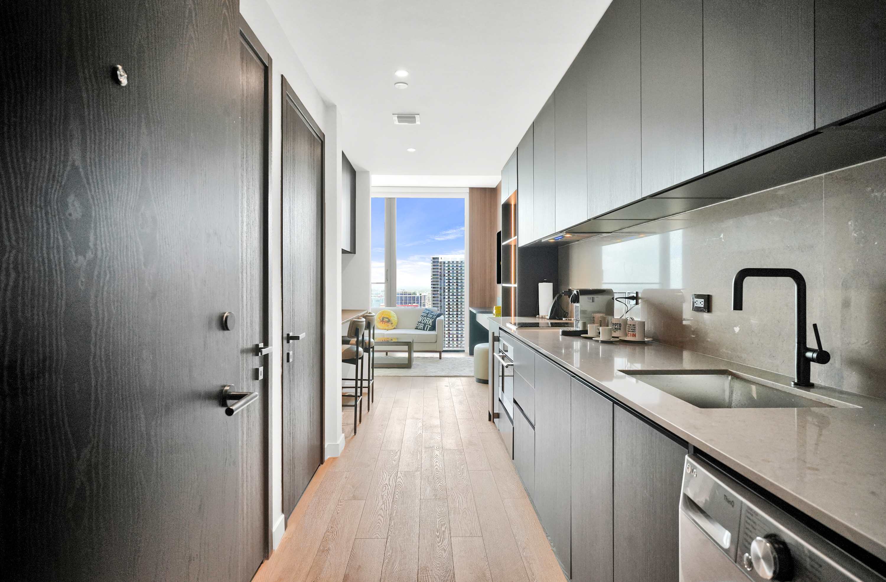 Galley kitchen opening toward the bright studio.