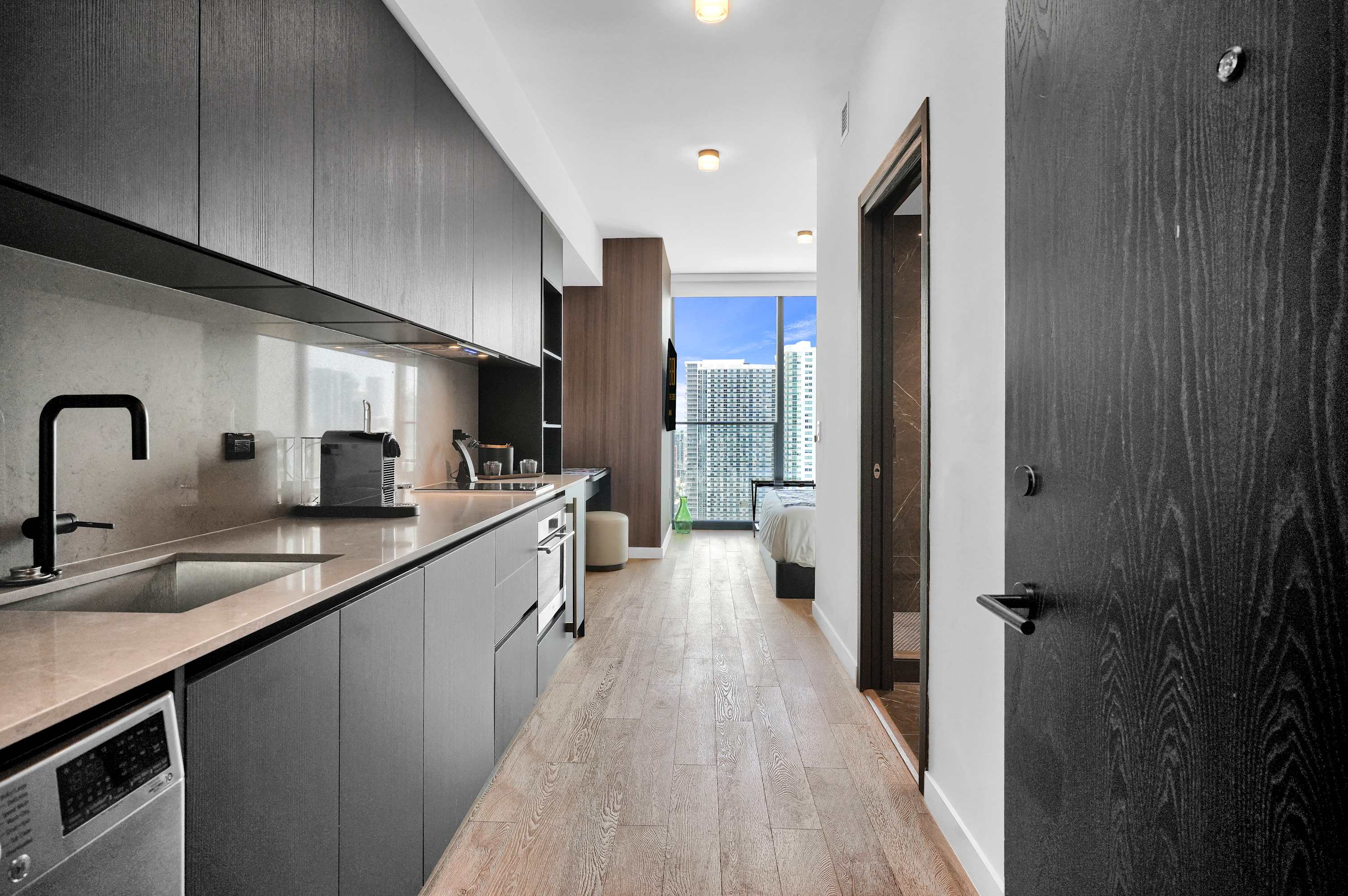 Galley kitchen opening toward the bright studio.